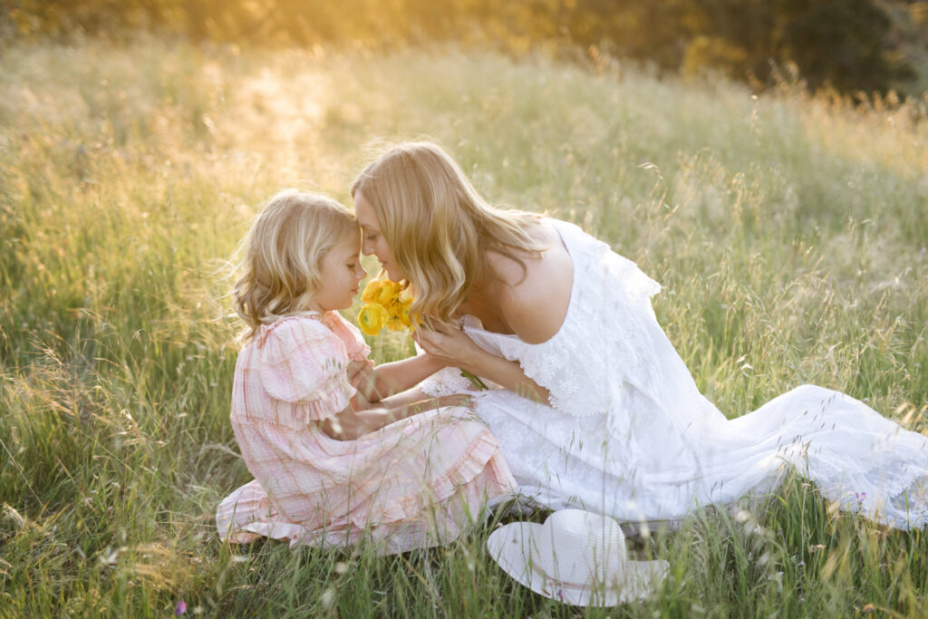 Mum wearing a flowing white dress during a family photography session in Perth with her daughter.