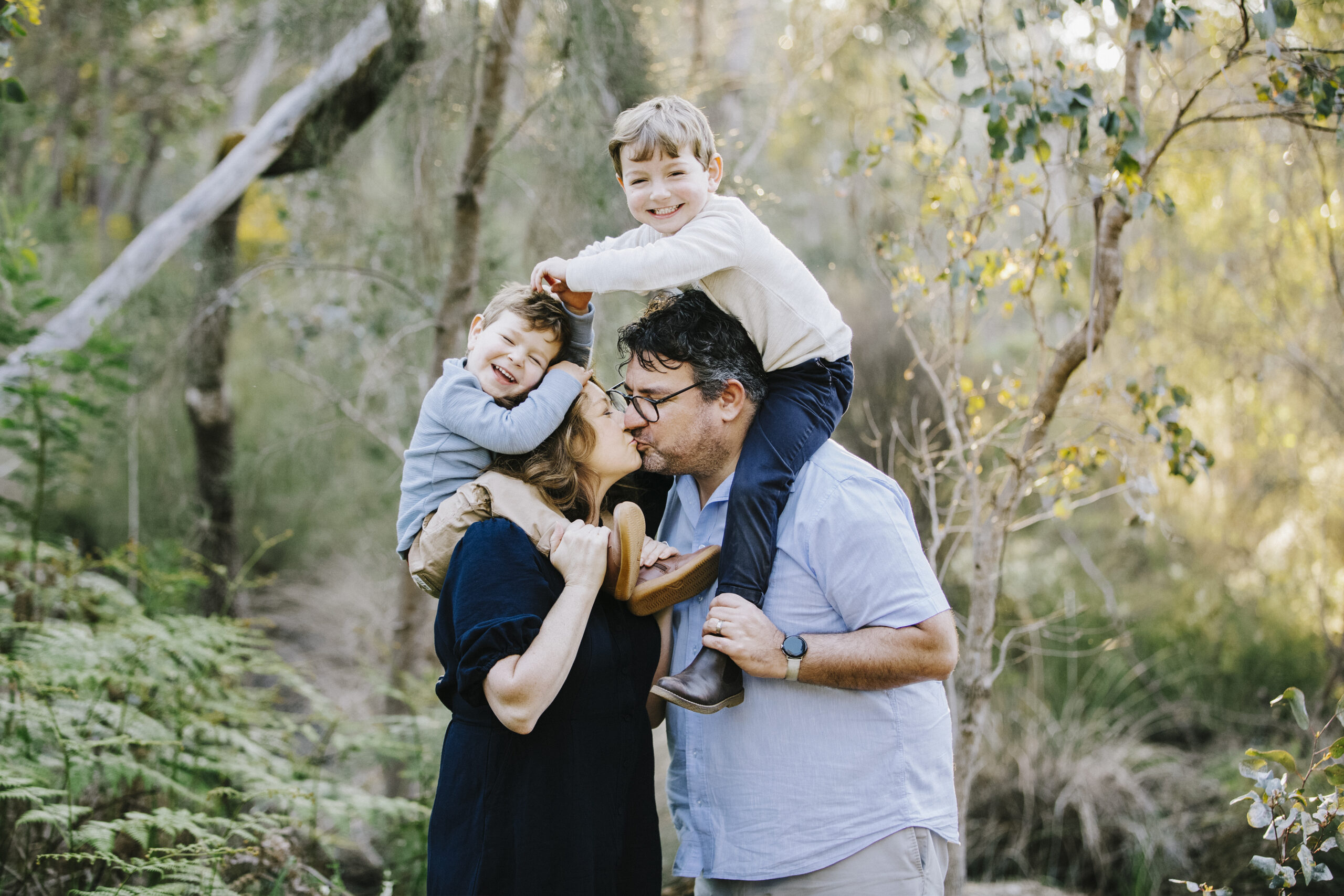 Family wearing coordinated outfits during an outdoor family photography session in Perth