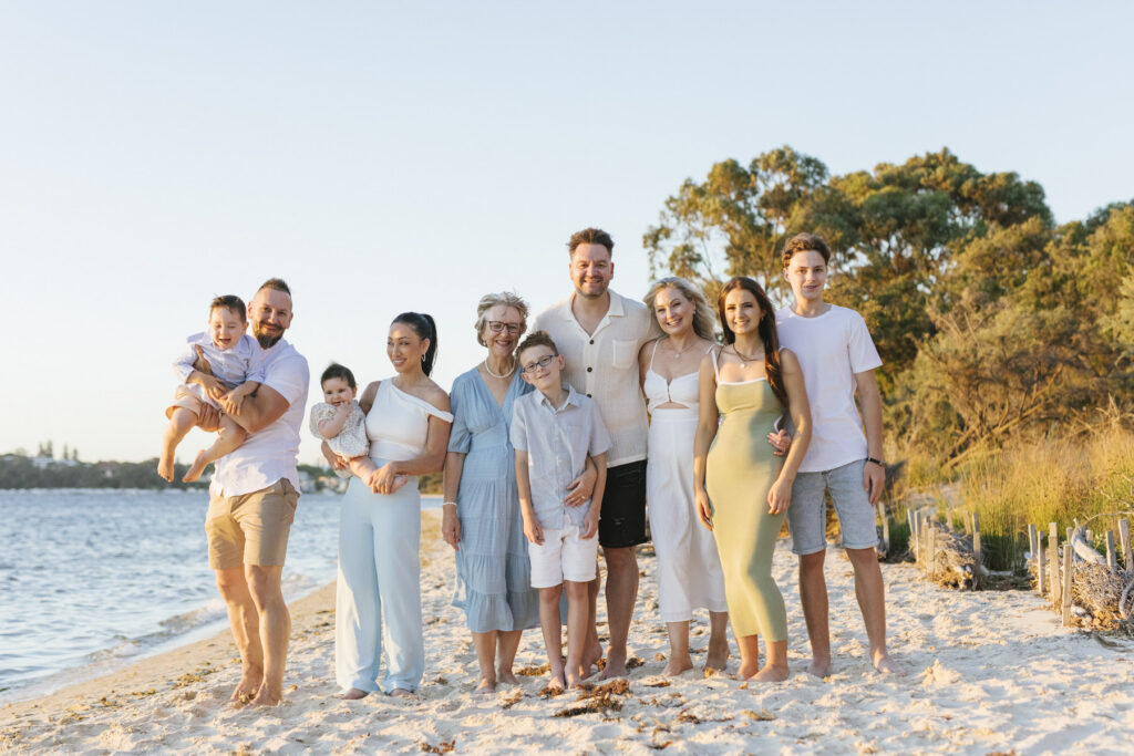 Extended family portrait on the beach during golden hour at Bishop Road Reserve, Perth, capturing three generations together.